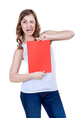 Image showing Beautiful girl with a red sheet of paper winks