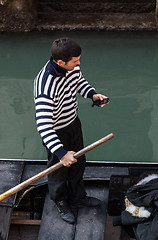 Image showing Gondolier Checking his Mobile Phone