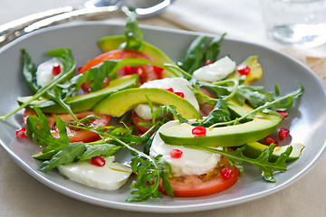 Image showing Avocado with mozzarella,pomegranate and rocket salad