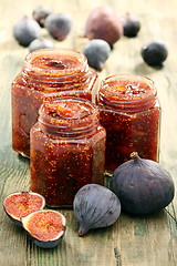 Image showing Figs and homemade jam in glass jars. 