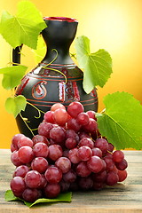 Image showing Pitcher and bunch of grapes.