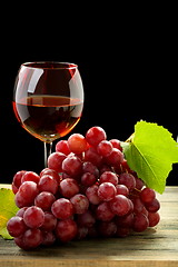 Image showing Bunch of grapes and glass of wine.