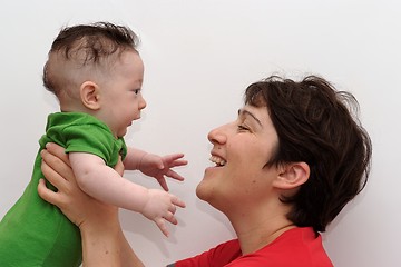 Image showing Cute baby held by his smiling mother profile view 