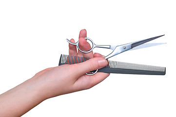 Image showing scissors and comb in the hand