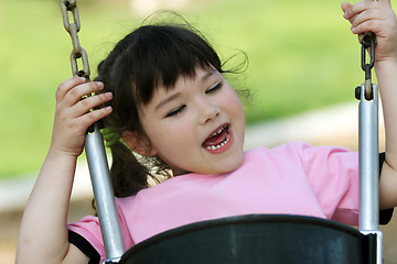 Image showing Cute girl swinging