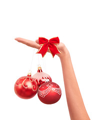 Image showing three Christmas-tree balls in the hand