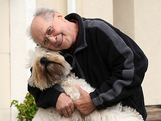 Image showing Happy senior man and his dog