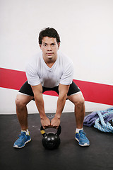 Image showing Young man Lifting Crossfit Kettle Bell