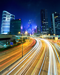 Image showing traffic light through city at night