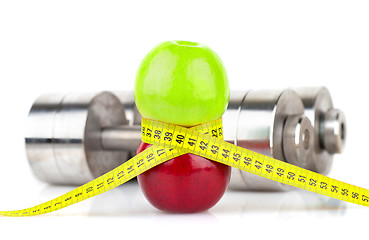 Image showing Apples, measuring tape and dumbbells