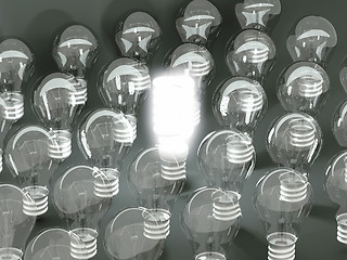 Image showing New idea or invention: illuminated efficient bulb among old ones