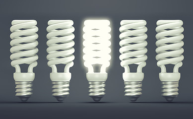 Image showing Idea or invention: illuminated efficient bulb among group of off