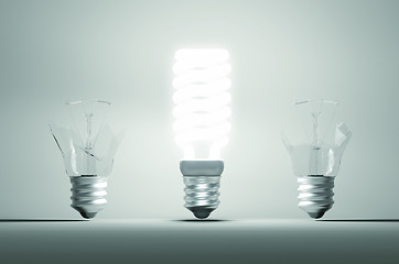 Image showing Idea and mistake or failure: illuminated bulb among two broken o