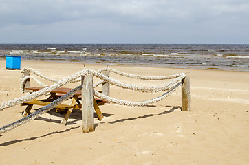 Image showing Rope log fence beach sand table bench waste bin 