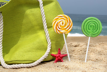 Image showing Green beach bag, two candles and funny sea star