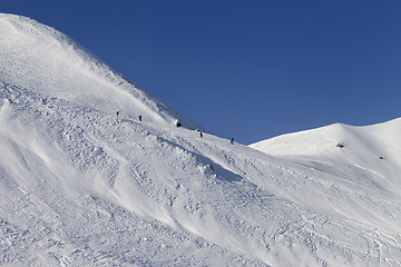 Image showing Skiers and snowboarders on ski piste