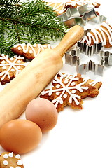 Image showing Christmas ginger biscuits, eggs, rolling pin and dough forms.