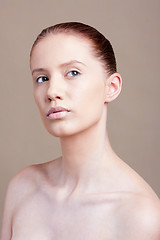 Image showing Portrait of young beautiful woman with clear make-up over brown background 