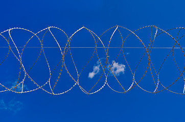 Image showing Barbed wire against the sky