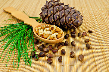 Image showing Nuts and cone of cedar on a bamboo mat