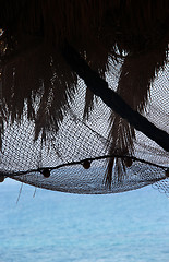 Image showing View of morning sea with palm tree silhouettes and fishing nets