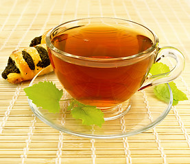 Image showing Tea with mint and cookies on a bamboo napkin