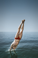 Image showing man jumping in the lake