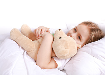 Image showing Cute girl cuddling with teddy bear