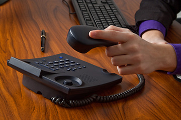 Image showing Businessman replacing telephone receiver