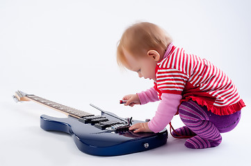 Image showing Little girl playing with guitar
