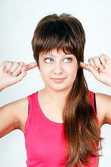 Image showing girl plugs fingers in his ears