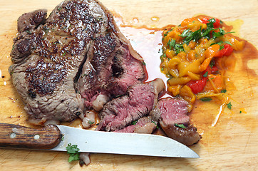 Image showing Steak sliced on a board
