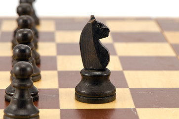 Image showing Knight stand in front of all pawn chess line board 