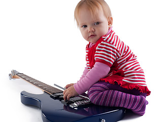 Image showing Little girl playing with guitar