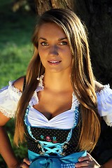 Image showing Bavarian Woman in Nature standing in front of a tree