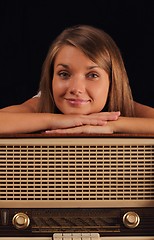 Image showing Woman leaning on antique radio