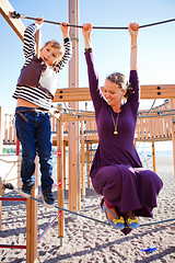 Image showing Mother and son playing at playground.