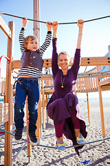 Image showing Mother and son playing at playground.