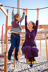 Image showing Mother and son playing at playground.