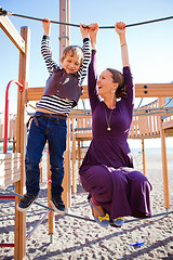 Image showing Mother and son playing at playground.