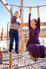 Image showing Mother and son playing at playground.