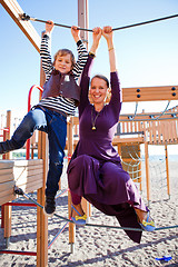 Image showing Mother and son playing at playground.