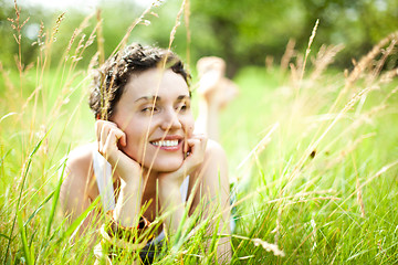 Image showing cute girl on green field 