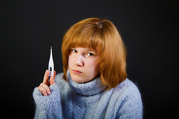 Image showing sick sad girl with a thermometer