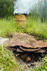 Image showing Smoke rises old barrel smokehouse firewood burn 