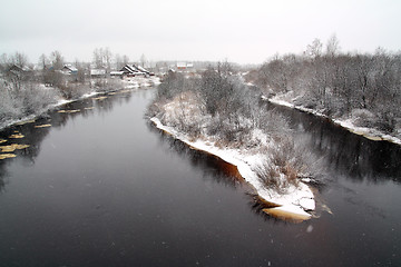 Image showing snow village on coast river 