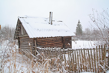 Image showing old rural wooden house amongst snow