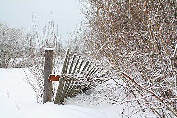 Image showing old wooden fence amongst white snow