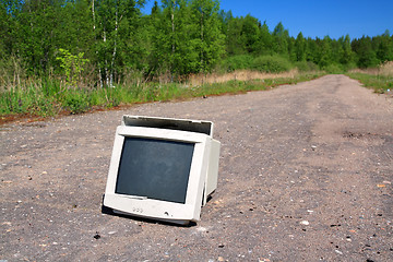 Image showing brokenned computer on old road