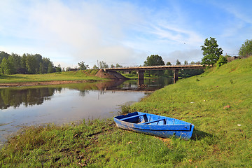 Image showing wooden boat on river coast near villages